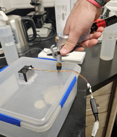 A scientist testing the wind tunnel apparatus